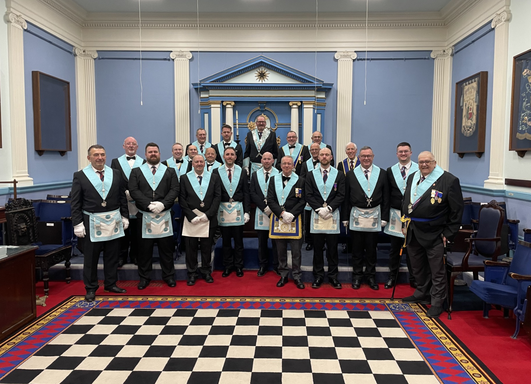 Beach Lodge members together in the blue and white lodge room at Albion Place